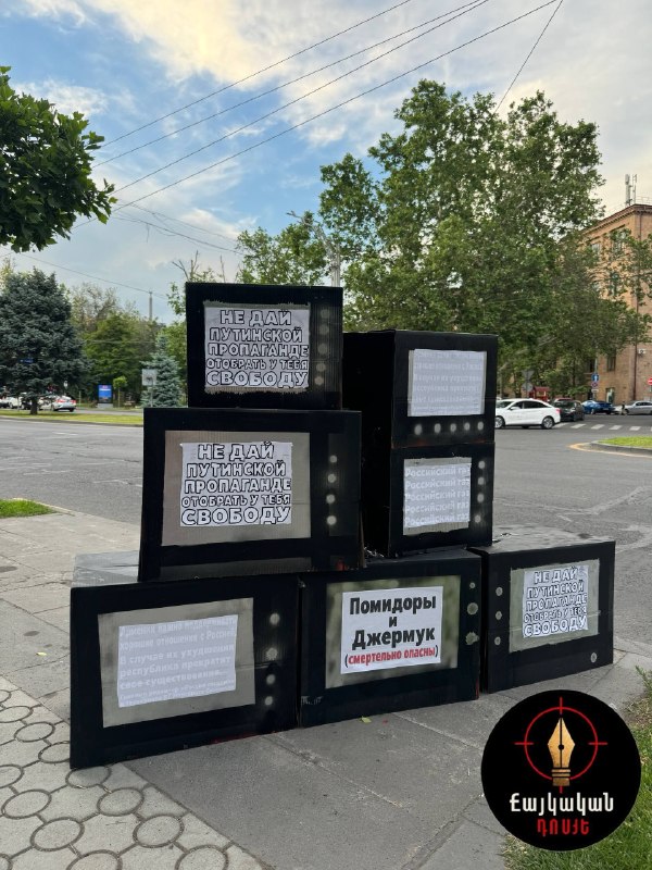 Инсталляции против пропаганды в Ереване, демонстрирующие картонные телевизоры и окровавленную пешку, обсуждаемые в контексте